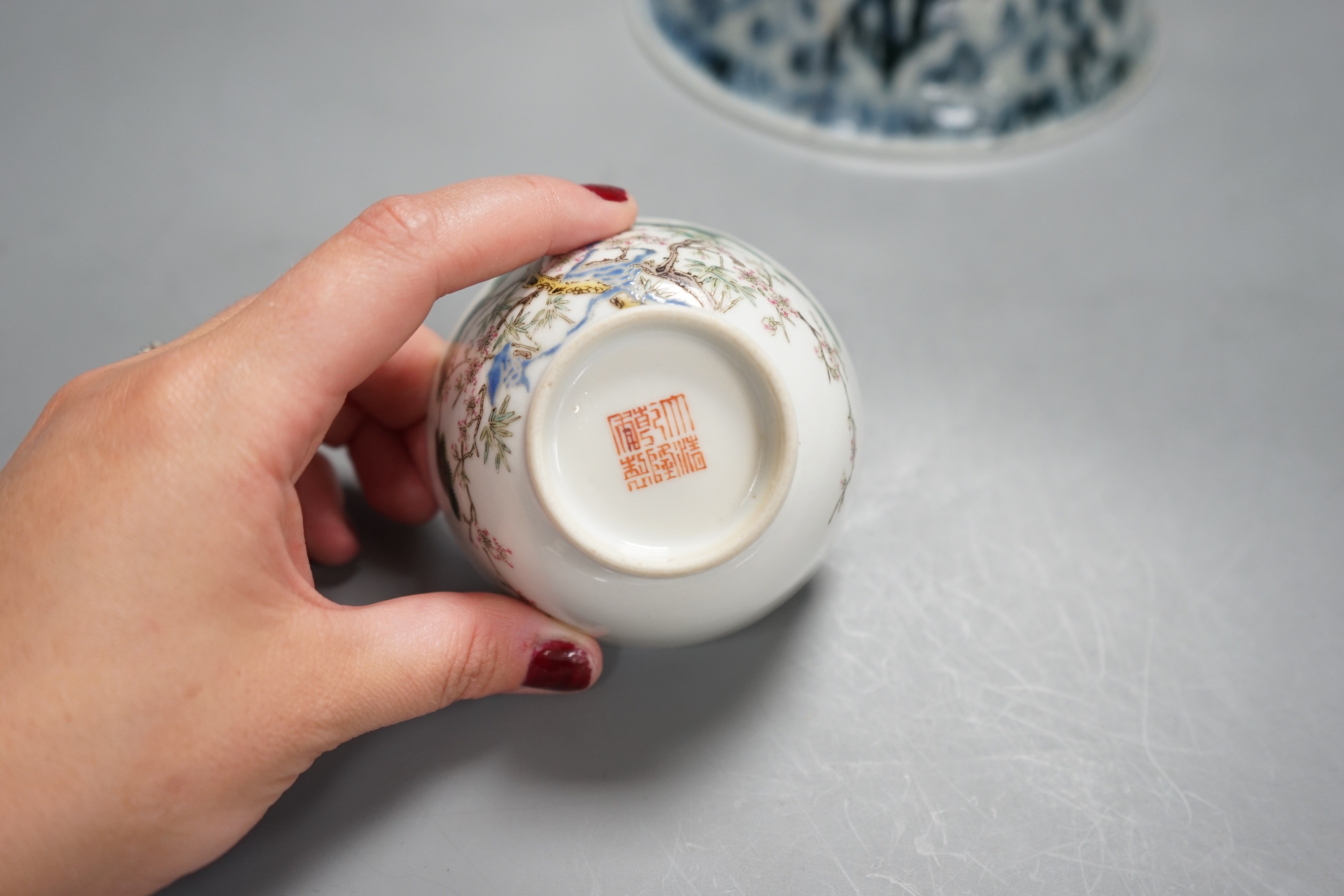 A Chinese Ming blue and white bowl, a larger famille rose bowl and a tea bowl, largest 21cm